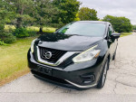 2015 Nissan Murano S AWD, black SUV parked on a road with green surroundings, showcasing sleek design and features.