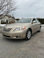 2007 Toyota Camry XLE in gold color, showcasing leather interior and sunroof, with 35,000 miles on the odometer.