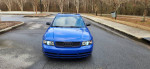2001 Audi S4 in Nogaro Blue, Stage 3 manual sedan with black leather interior parked in a scenic area
