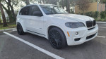 2010 BMW X5 displayed with new Vossen 22-inch wheels in a clean parking area