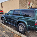 2015 Toyota 4Runner in green color parked, showcasing its unique Highlander edition features.