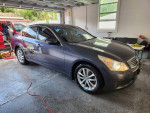 2009 Infiniti G37x sedan parked in a garage, showcasing its sleek design and clean condition.
