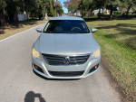 Front view of a 2009 Volkswagen CC Sport with low mileage, clean Carfax, parked on a scenic road.