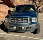 Front view of a blue 2001 Ford F350 Super Duty dually with low mileage, showcasing its rugged design and condition.