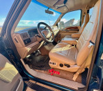 Interior view of 2001 Ford F350 Super Duty Crew Cab with leather seats and dashboard controls.