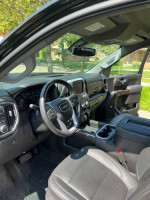Interior view of a 2021 GMC Sierra 1500 Denali showing dashboard and seating features.