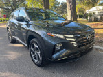 2024 Hyundai Tucson Limited SUV in excellent condition parked on a street with clear skies.