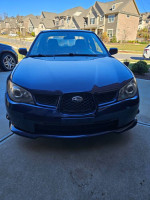 Front view of a 2006 Subaru Impreza 2.5i in blue, showcasing its clean design and sporty features.