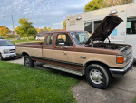 1987 Ford F250 pickup truck with the hood open, showcasing engine repairs and features for sale.