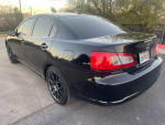 2011 Mitsubishi Galant in black, features backup camera, navigation, and sleek design with black rims.