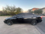Side view of a black 2011 Mitsubishi Galant with upgraded features parked outdoors.