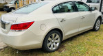 2011 Buick LaCrosse in immaculate condition with new tires, parked outdoors, showcasing its sleek design and shine.