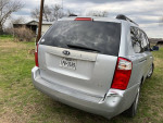 2008 Kia Sedona van in silver with minor rear damage, ideal family vehicle with spacious seating for seven.