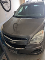 2011 Chevrolet Equinox gray SUV with minor mechanical issues parked in a garage