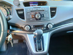 Interior view of a 2014 Honda CRV EX-L with dashboard, audio controls, and gear shift.