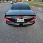 Rear view of a black 2008 Mercedes-Benz SL 550, showcasing its sleek design and Texas license plate.