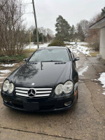 2008 Mercedes-Benz SL 550 convertible with 69,000 miles, parked on a snowy driveway.