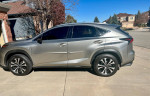 Profile view of a 2018 Lexus NX 300 FWD in silver, showcasing its sleek design and alloy wheels.