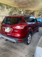2014 Ford Escape S FWD in red, parked, features clean body with tan leather interior, well maintained and no accidents.