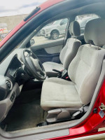 Interior view of a 2003 Subaru Impreza Outback Sport with gray seats and dashboard
