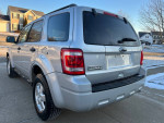 2012 Ford Escape XLT AWD in silver parked in front of a house, showcasing its clean exterior and new tires.