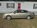 2005 Lexus ES parked outside a mobile home, showing its side view and good condition after maintenance.