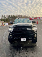 Front view of a 2021 Ram 2500 Crew Cab Big Horn lifted truck with black exterior and large tires.