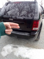 Rear view of a black Jeep Cherokee 2006 Laredo, showcasing clean lines and a well-maintained exterior.