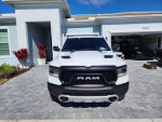 Front view of a 2022 Ram Rebel extended cab truck parked in a driveway.