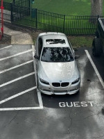 Silver 2009 BMW 335i parked in guest space, showcasing its sleek design and recent maintenance upgrades.