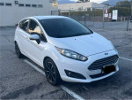 2015 Ford Fiesta in white, 83,000 miles, clean interior, new brakes, Bluetooth, parked in lot