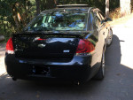 2007 Black Chevrolet Impala SS with rear view, showcasing sleek design and features, parked in a scenic area.