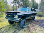 1989 Chevrolet Suburban project vehicle with a lift and no engine, showcasing its clean title and classic design.