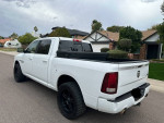 2013 Ram 1500 Sport Crew Cab in white, featuring 4WD, black wheels, and a clean exterior, parked on a residential street.