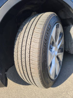 Close-up of a Michelin tire mounted on a Tesla Model Y, showcasing tread pattern and wheel design