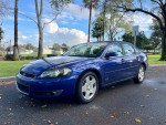2006 Chevrolet Impala SS for sale, blue color, showing side view in a park setting, reliable with 112k miles.