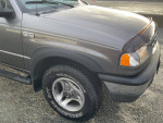 2007 Mazda B4000 truck in excellent condition with new tires and no rust, showcasing the front side and wheel.