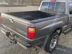 Rear view of a 2007 Mazda B4000 truck with new tires and a clean bed, featuring 4X4 badge.