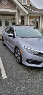 2016 Honda Civic EX sedan in gray color parked outside, featuring sunroof and sporty design.