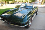 1967 Chevrolet Corvette Convertible in dark green, showcasing a restored exterior and bright chrome accents