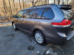 2011 Toyota Sienna Limited AWD in gray, showcasing its sleek design and spacious side view.