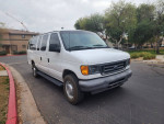2004 Ford E-350 12 passenger van in excellent condition parked on a residential street.