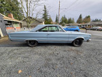 1967 Plymouth Satellite in blue, featuring a factory A/C and new parts, parked on gravel driveway.