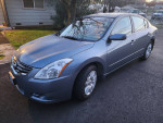 2012 Nissan Altima S Model with 123,400 miles, clean title and no accidents, parked on a driveway.