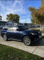 2020 INFINITI QX80 SUV with 55K miles parked on driveway, showcasing its sleek design and luxury features.