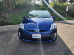 2011 Toyota Prius One in blue with gray interior, showcasing front view and California license plate.