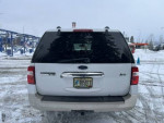 Rear view of a 2009 Ford Expedition Eddie Bauer in snow, showcasing its spacious design and two sets of tires.