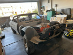 1969 Chevrolet Camaro project car with a partially built 72 Chev 454 engine inside a garage.