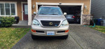 Front view of a 2004 Lexus GX 470 in a residential driveway, showcasing clean lines and well-maintained condition.