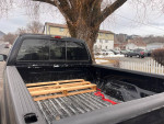 1999 Ford F350 Super Duty truck bed with wooden pallets for hauling, showcasing durability and potential for restoration.